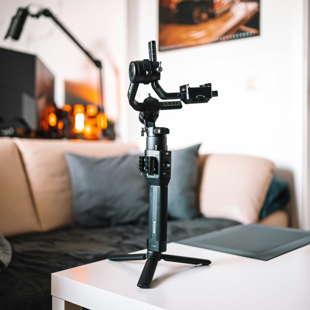 A camera gimbal placed on a coffee table in a living room